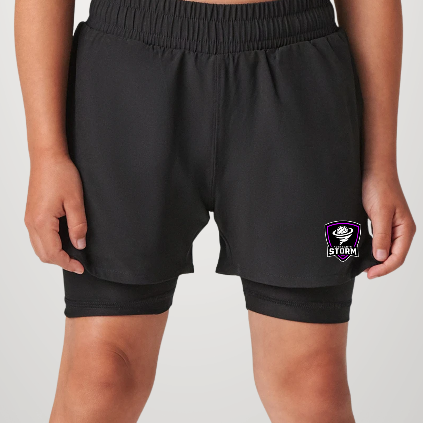 Black double-layered athletic shorts with an elastic waistband and a purple and white Storm logo on the left leg, shown on a model against a light gray background.