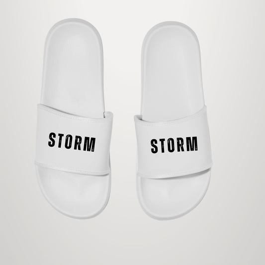 A pair of white slide sandals with the brand name 'STORM' printed in black capital letters across the strap, shown against a light gray background.