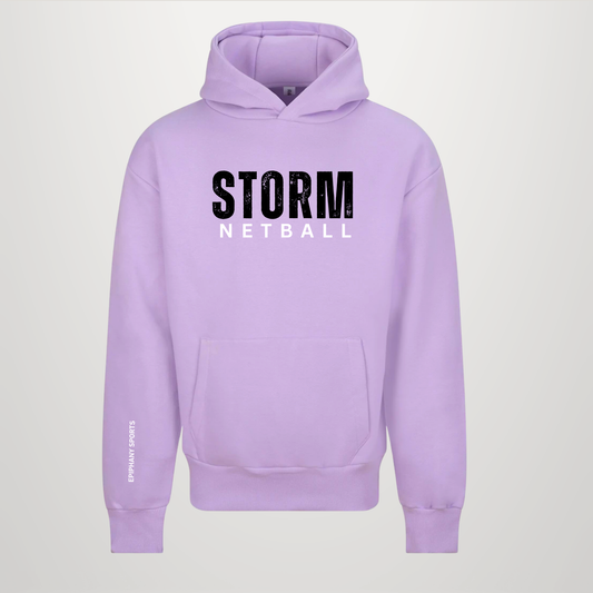 A light purple/lavender pullover hoodie with 'STORM NETBALL' printed on the chest in black and white, and 'STORMING SPORTS' on the left sleeve, shown against a light gray background.
