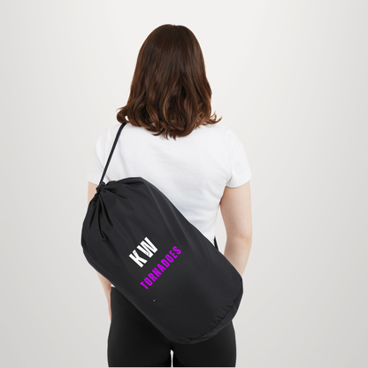 A woman shown from behind wearing a white t-shirt and black pants, carrying a black drawstring bag over her shoulder. The bag features the text 'KIN TOMORROWS' in white and purple on the side.