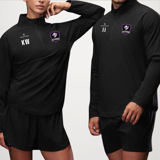 Two models wearing matching black long-sleeve quarter-zip athletic tops and shorts sets with custom white initials and a purple and white club crest on the chest, set against a plain light gray background.